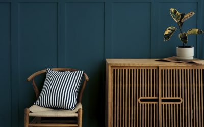 scandinavian-vintage-wood-cabinet-with-chair-by-dark-blue-wall_53876-98164